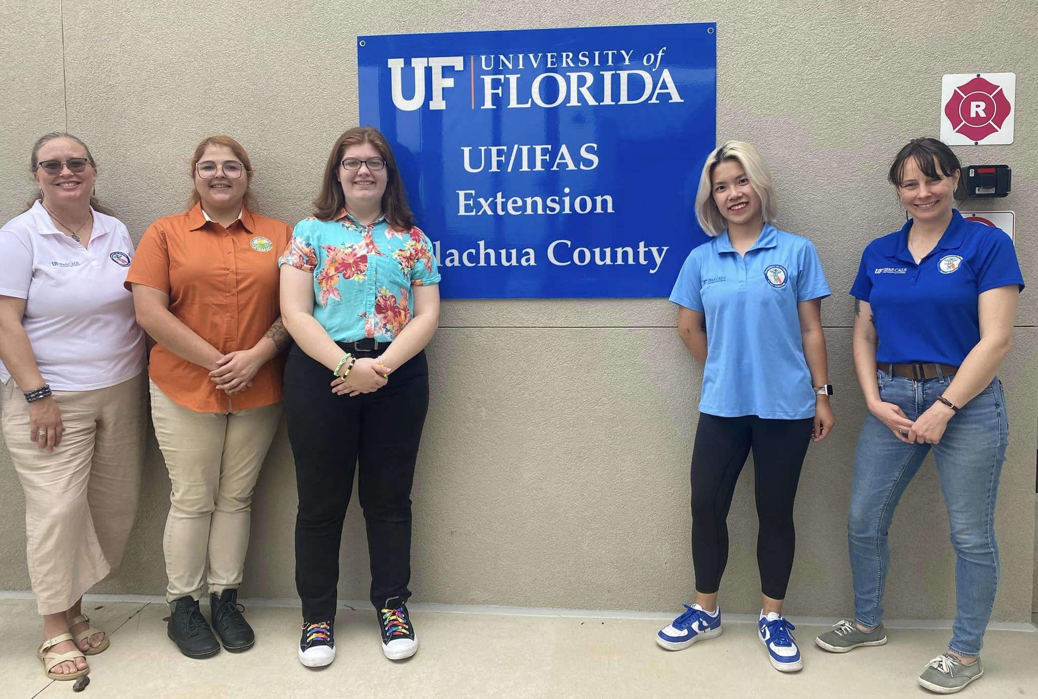 Florida First Detector team standing in front of Alachua County extension office sign